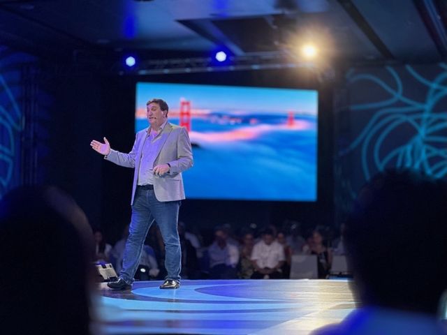 Mariano on a large stage in front of a full audience