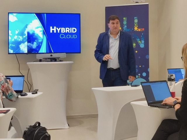 Mariano leading a hybrid cloud workshop for a team working on laptops